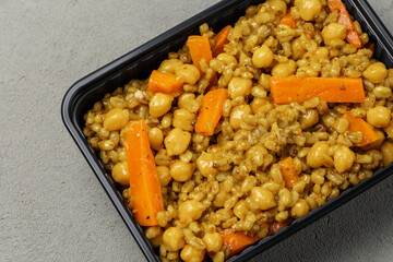 Vegetarian pilaf in a biodegradable shipping container