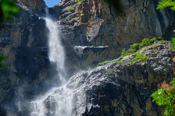 Fototapeta na wymiar high in the mountains waterfall on the rocks