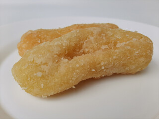 Getas, is a traditional cake from Indonesia. Made from grated coconut and rice flour, then fried and dipped into sugar. Isolated in white background. Top view or flat lay