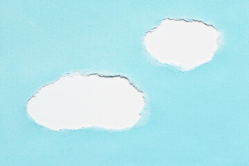 Blue torn ripped paper holes on white paper background