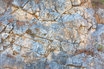 Fragment of stones rock with some blue tone and with a lot of cracks