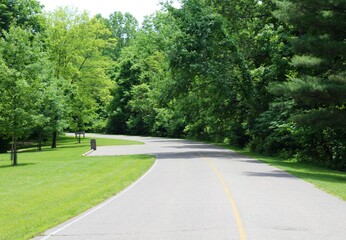 A view of the empty road in the country on a sunny day.