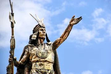 Fotobehang close-up of statue of Inca Pachacutec in Cusco, Peru against blue sky © Christian Horz