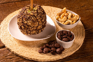 Candied apples on sticks with chocolat and peanut.