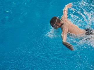 Male swimmer at the swimming pool. Underwater photo. Male swimmer.