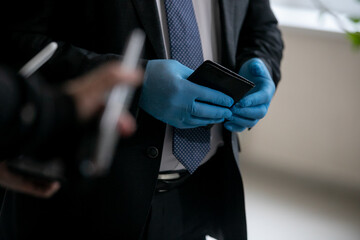 Man in blue medical gloves holds a passport in his hands.