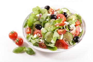 plate of mixed salad with tomato, olive, cucumber and feta cheese