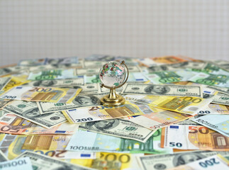 Globe on the desk and euro and dollar banknotes. Money and globus on the desk. Travel and money concept