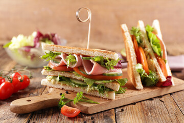 club sandwich with ham, lettuce, cucumber and tomato