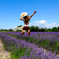 woman jumping in lavender flower field- france landscape provence