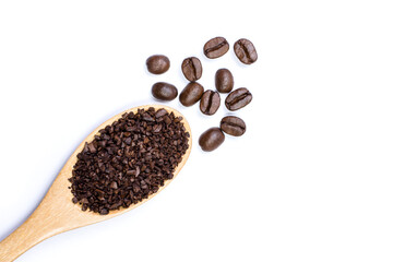 Close up instant granulated coffee with roasted coffee beans in wooden spoon isolated on white background. Top view. Flat lay.