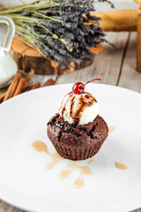 Chocolate muffin with a ball of ice cream 