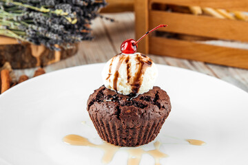 Chocolate muffin with a ball of ice cream 
