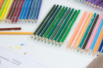 Colored pencils on a white background, close-up photo.