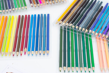 Colored pencils on a white background, close-up photo.