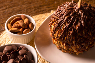 Candied apples on sticks with caramel, chocolate and almonds.