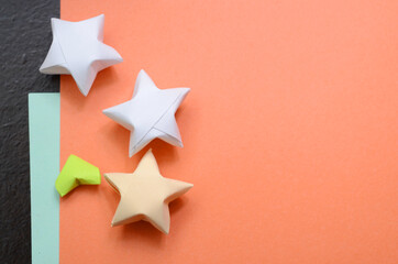 folding origami hearts and stars on table