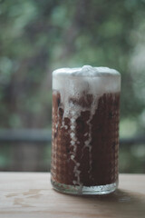 Ice coffee with cream in a tall glass