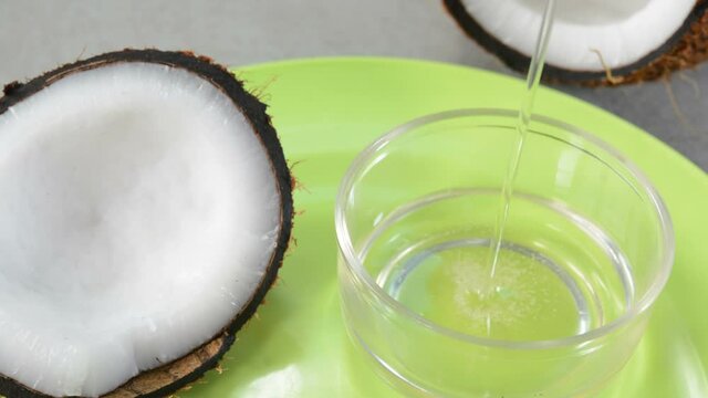 Pouring Coconut Oil In A Glass Cup