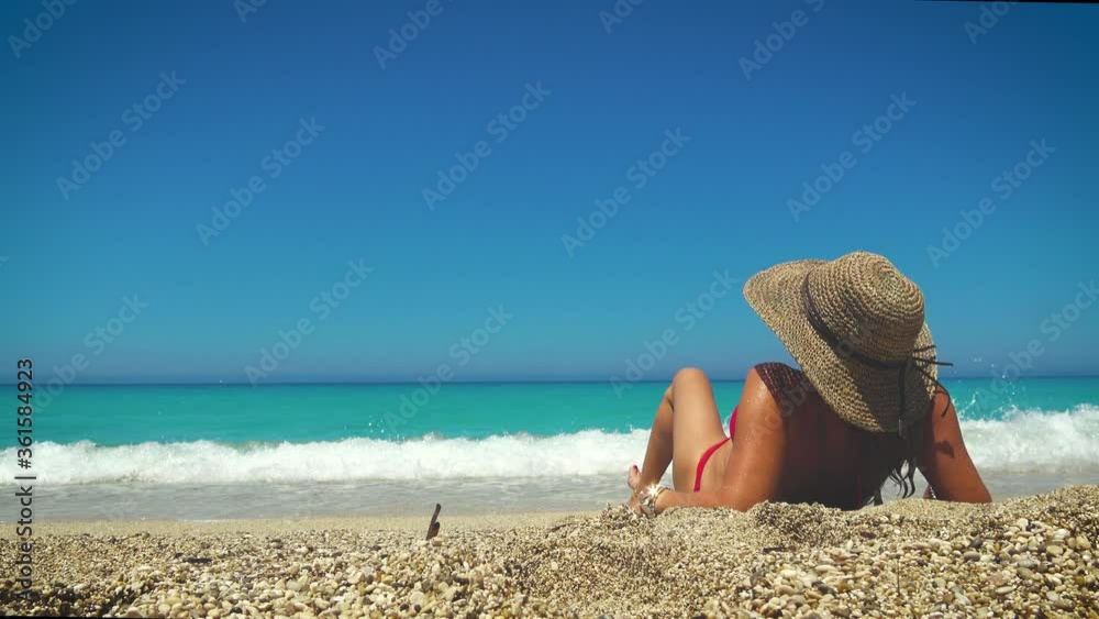 Wall mural Woman enjoying the beach at Greek island r