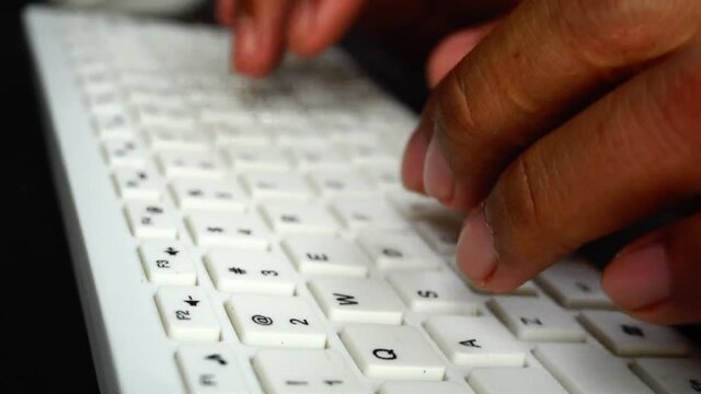 His hand working with computer and mouse keyboard
