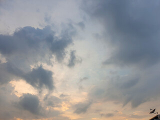 Fototapeta na wymiar The evening sky with dark clouds, rain preparing to fall. Can see the dish satellite TV