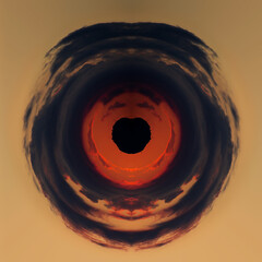 The Red Storm. Photo with the effect of polar coordinates. Round image of a bright orange sunset and storm clouds