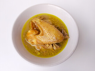 Chicken braised in coconut milk with turmeric. Indonesian food called Opor Ayam. Signature dish for Eid Holiday. Isolated in white background.