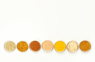 Condiments and herbs on white background. Flat lay. Top view.	
