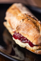 French baguette with hot Camembert cheese with jam