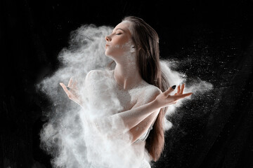 Girl dansing with flour on black background one person