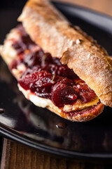 French baguette with hot Camembert cheese with jam
