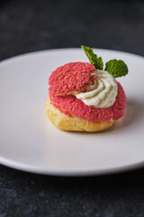 Choux pastry. Shu with cream of cottage cheese and cream. Dessert decorated with mint.