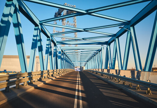 Front view of a modern road bridge in industrial area at sunset.
