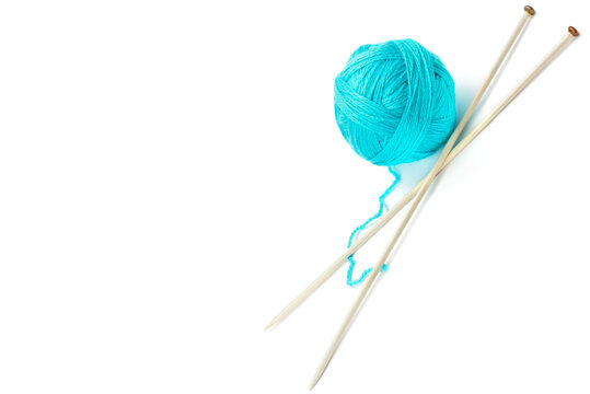 Ball of woolen thread and knitting needles isolated on white background. Free space for text.