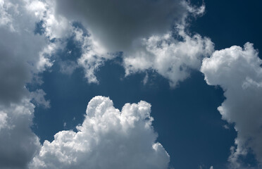 Picturesque snow-white cumulus clouds in the sky.