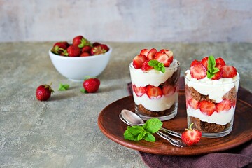 Dessert, truffle with chocolate biscuit, fresh strawberries and custard or cream cheese in glasses
