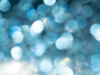 Fototapeta premium Abstract colorful blue bokeh effect texture on black background. glitter vintage lights defocused elegant for Christmas or celebrate. Sparkling magical dust particles.