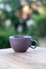 Cup of tea or coffee, served in a garden. Selective focus.