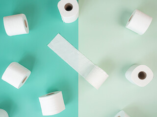 White Toilet Paper Rolls On pastel green background.