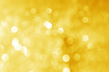 abstract defocused yellow bokeh sparkling light glitter background. for wallpaper backdrop and...