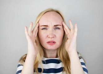 A woman suffers from headache or hypertension. The concept of treatment and prevention of migraine