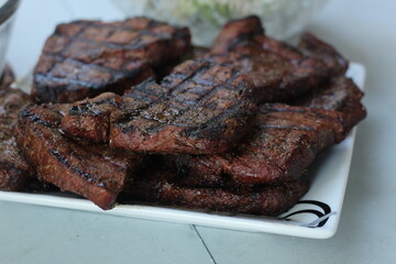 Grilled steak on white plate
