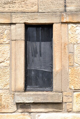 Dark Window & Stone Surround in Old Wall with Rough Textured Surface 