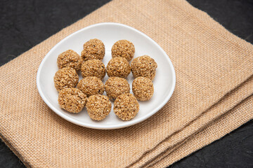 Sesame seeds balls - sweet made with sesame and palm sugar. Tilgul Laddu or Til Gul balls for makar sankranti, Roasted thala balls. Indian snacks