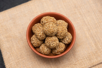 Sesame seeds balls - sweet made with sesame and palm sugar. Tilgul Laddu or Til Gul balls for makar sankranti, Roasted thala balls. Indian snacks