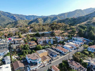 Fototapeta na wymiar Aerial view of Avalon downtown with their houses on the cliff in Santa Catalina Island, famous tourist attraction in Southern California, USA
