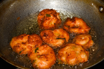 south indian cuisine - Vada or Medu vadai frying in coconut oil. Very popular south Indian snack.