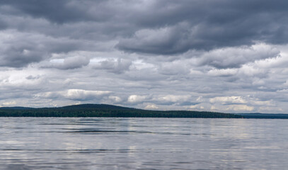 Fototapeta premium view of the lake and cumulus clouds