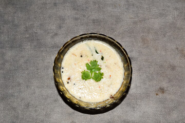 south indian cuisine - White coconut chutney served in a glass bowl.